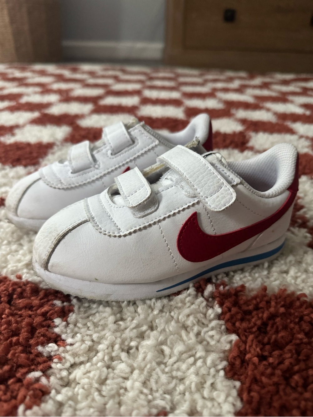 Nike Kids White Sneakers with Red Swoosh and Blue Accents